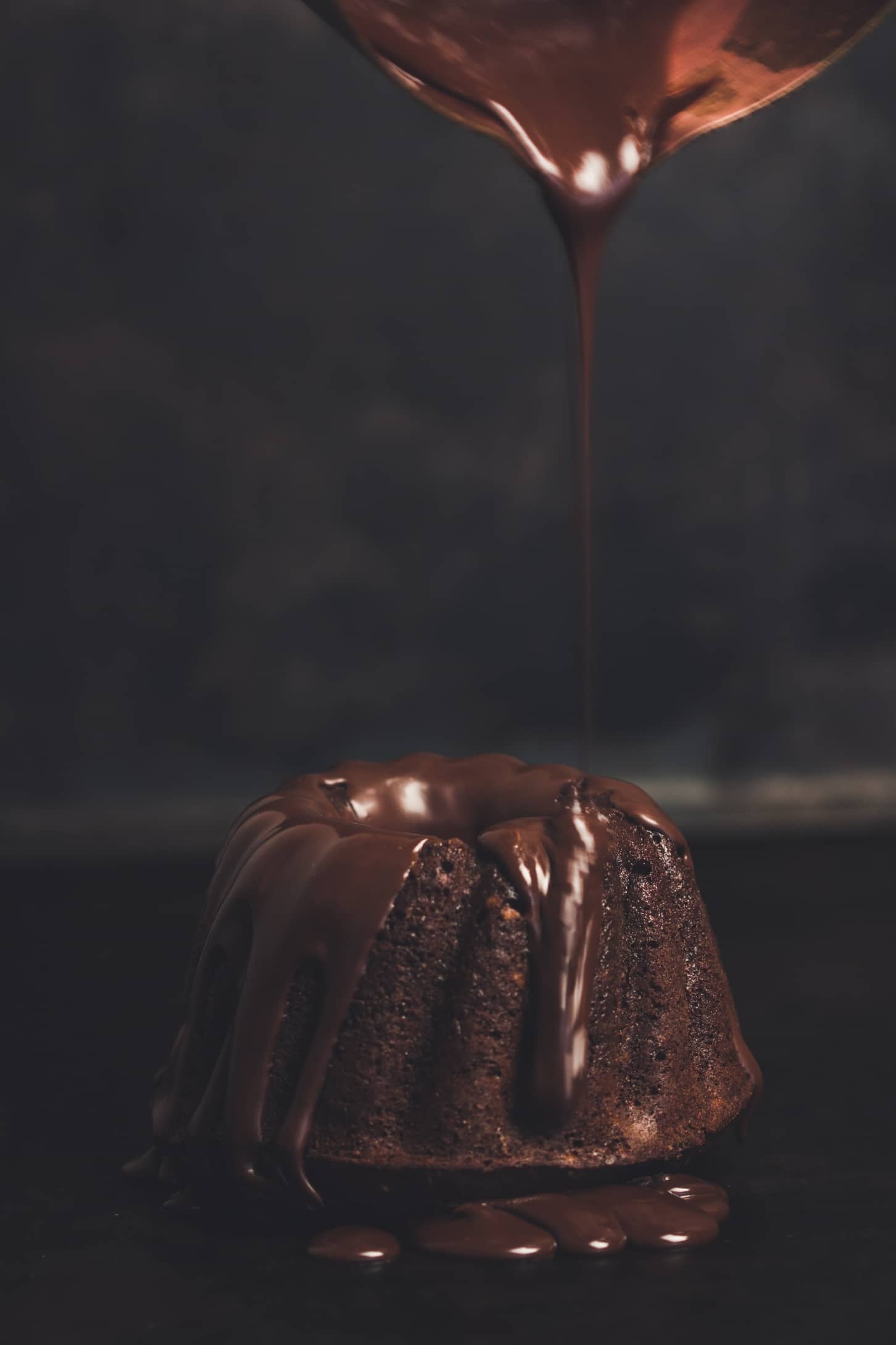 Chocolate beingpoured over a ring of chocolate cake