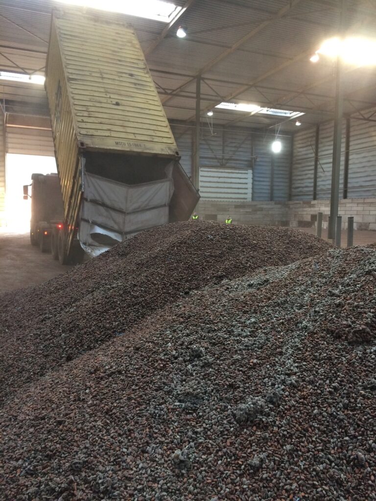 A truck unloads a container of cocoa beans from West Africa into a warehouse in Amsterdam.